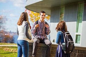 Students talking in front of a hall