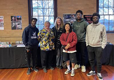 Students and Professor stand together at event